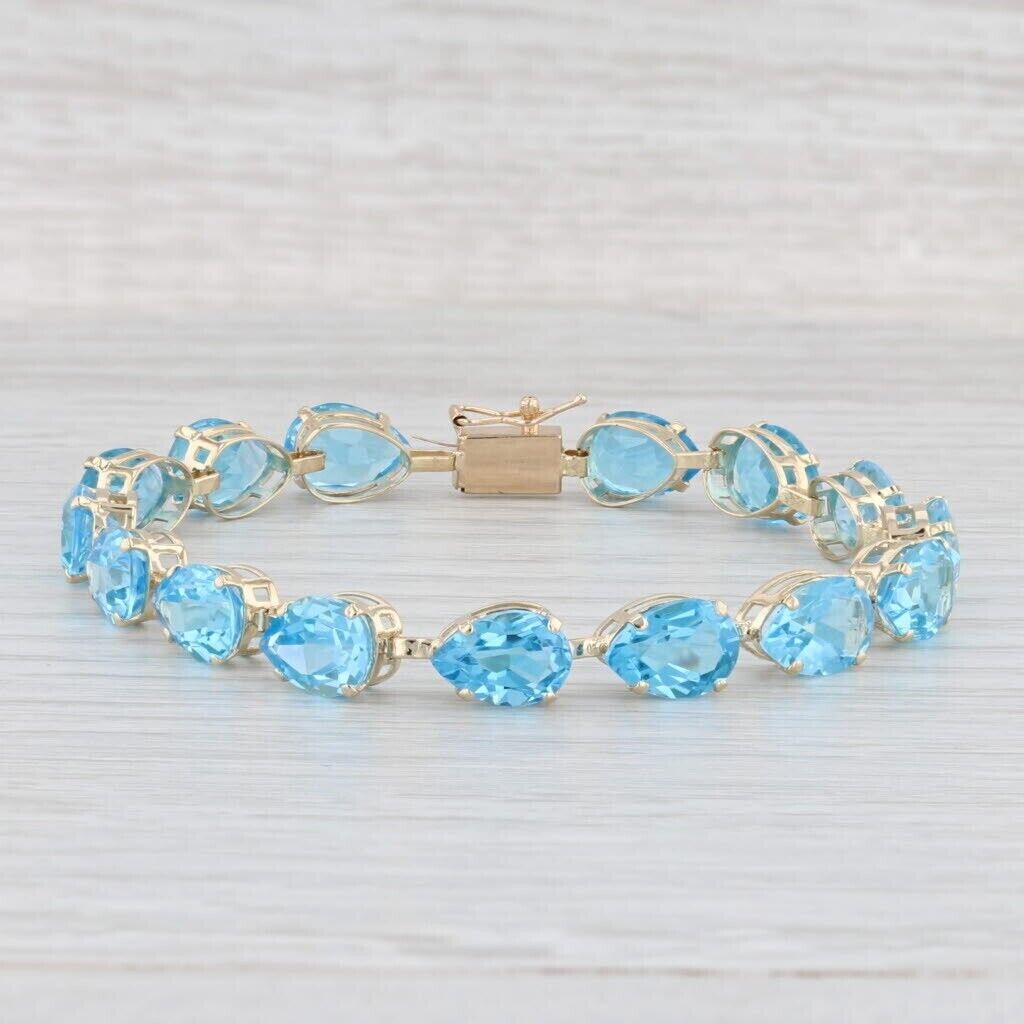 18.0Ct Pear Cut Lab Created Blue Topaz Tennis Bracelet In 14k Yellow Gold Plated.