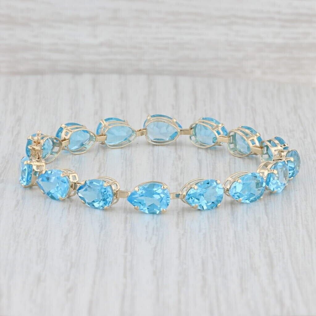 18.0Ct Pear Cut Lab Created Blue Topaz Tennis Bracelet In 14k Yellow Gold Plated.